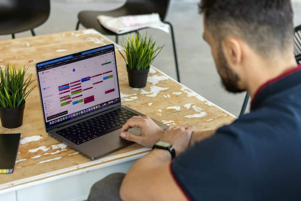 Business days calculator tool — man viewing calendar on laptop