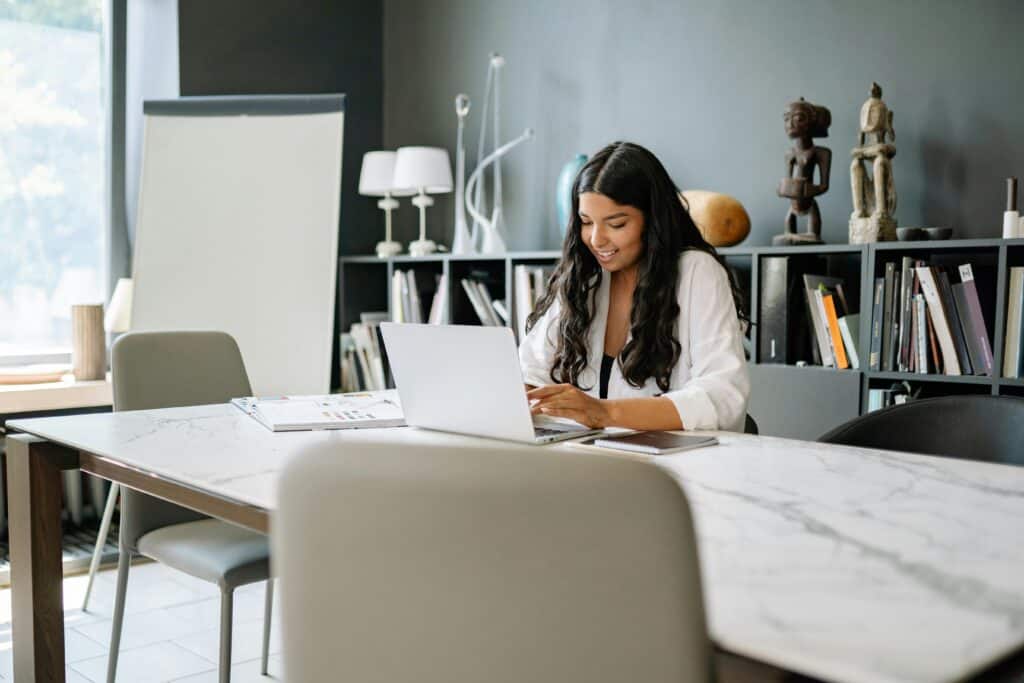 Contact WorkingDaysCalc — woman using working days calculator on laptop in office