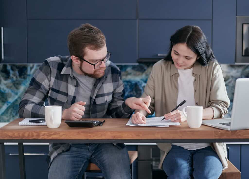 couple reviewing and signing paperwork at a kitchen table showing FTC 3-day cooling-off rule