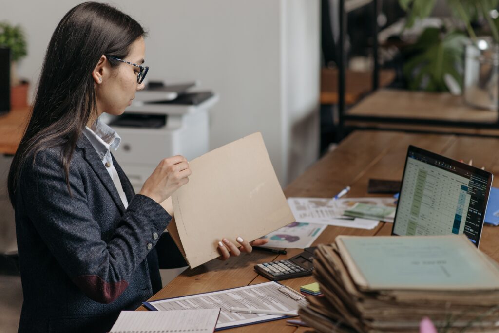 Woman reviewing employment documents at a desk learning how to calculate notice period